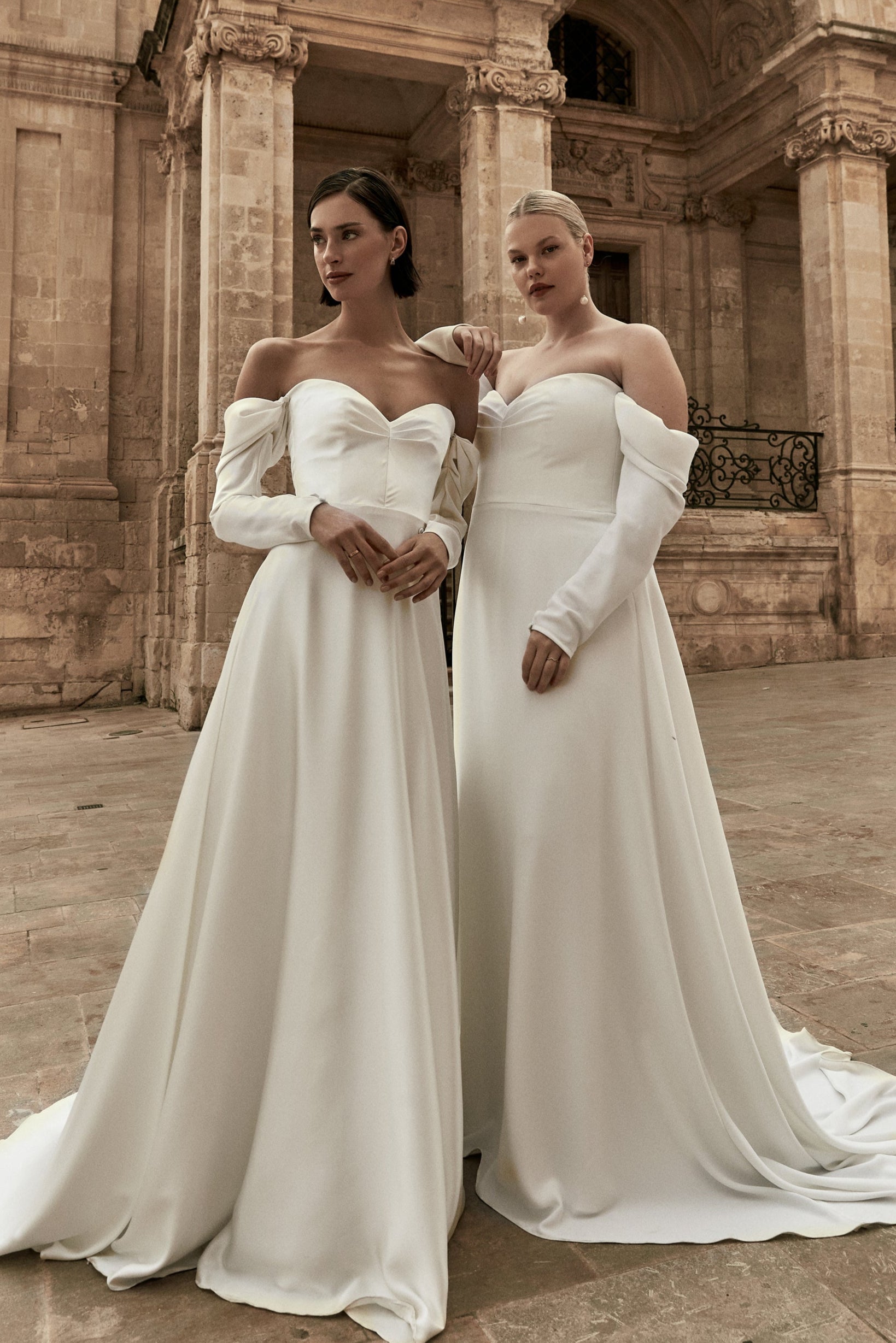 Augusta : A strapless wedding gown with a pleated bodice and draped off-shoulder sleeves