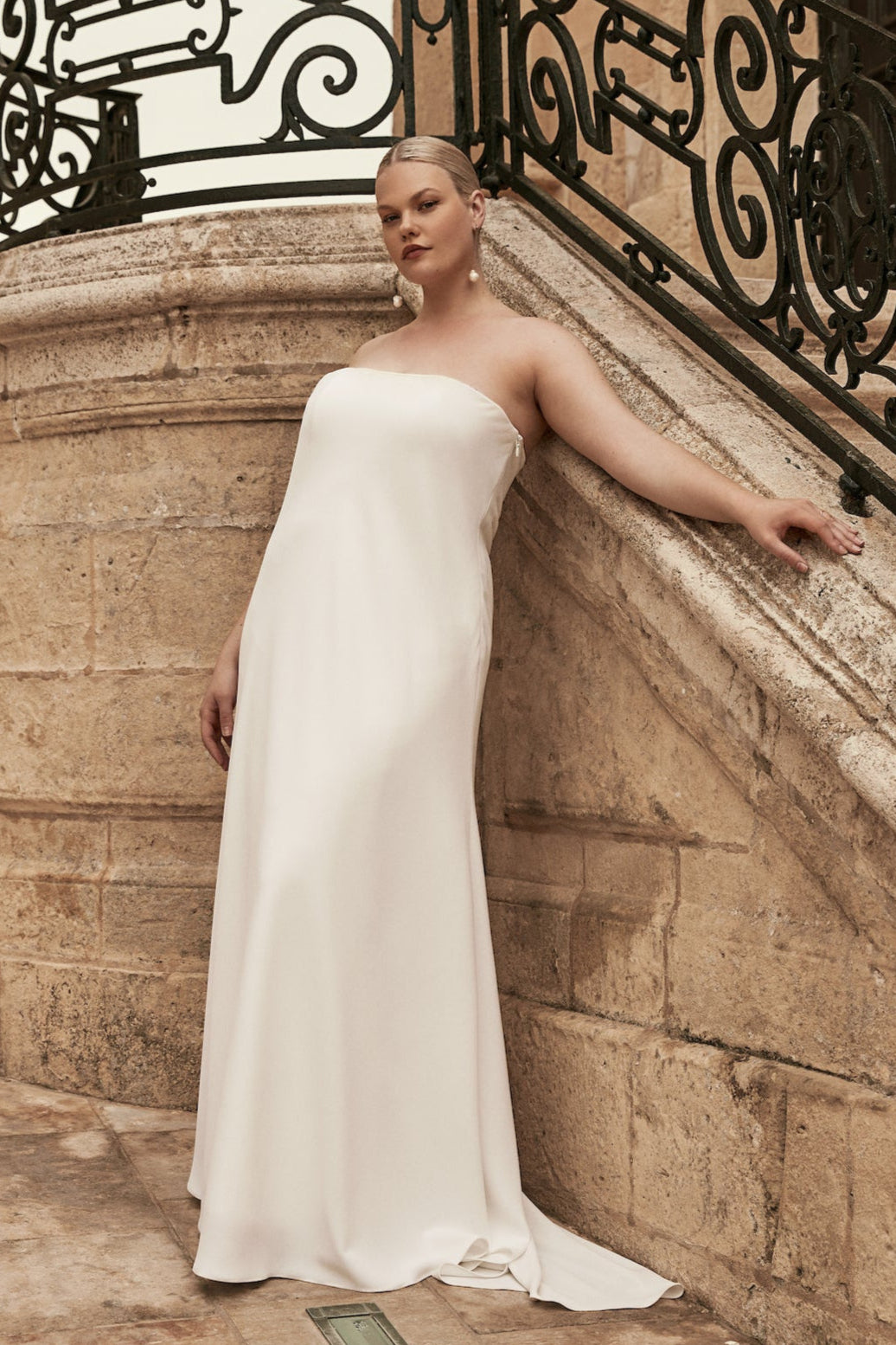 Leonora : A strapless, bias-cut wedding gown with a small train