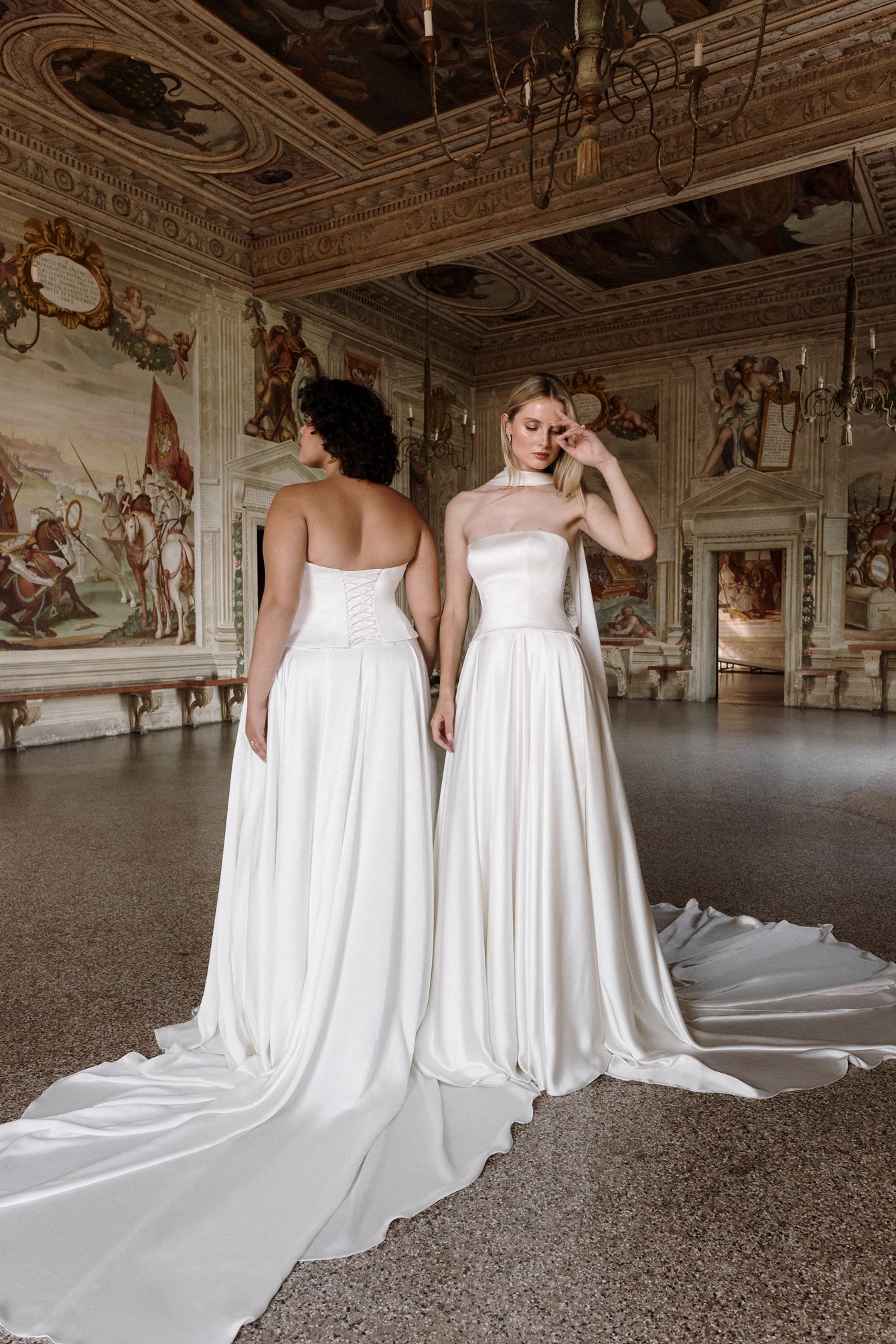 Gaia : A sleek satin wedding gown with a strapless neckline + a curved drop waist