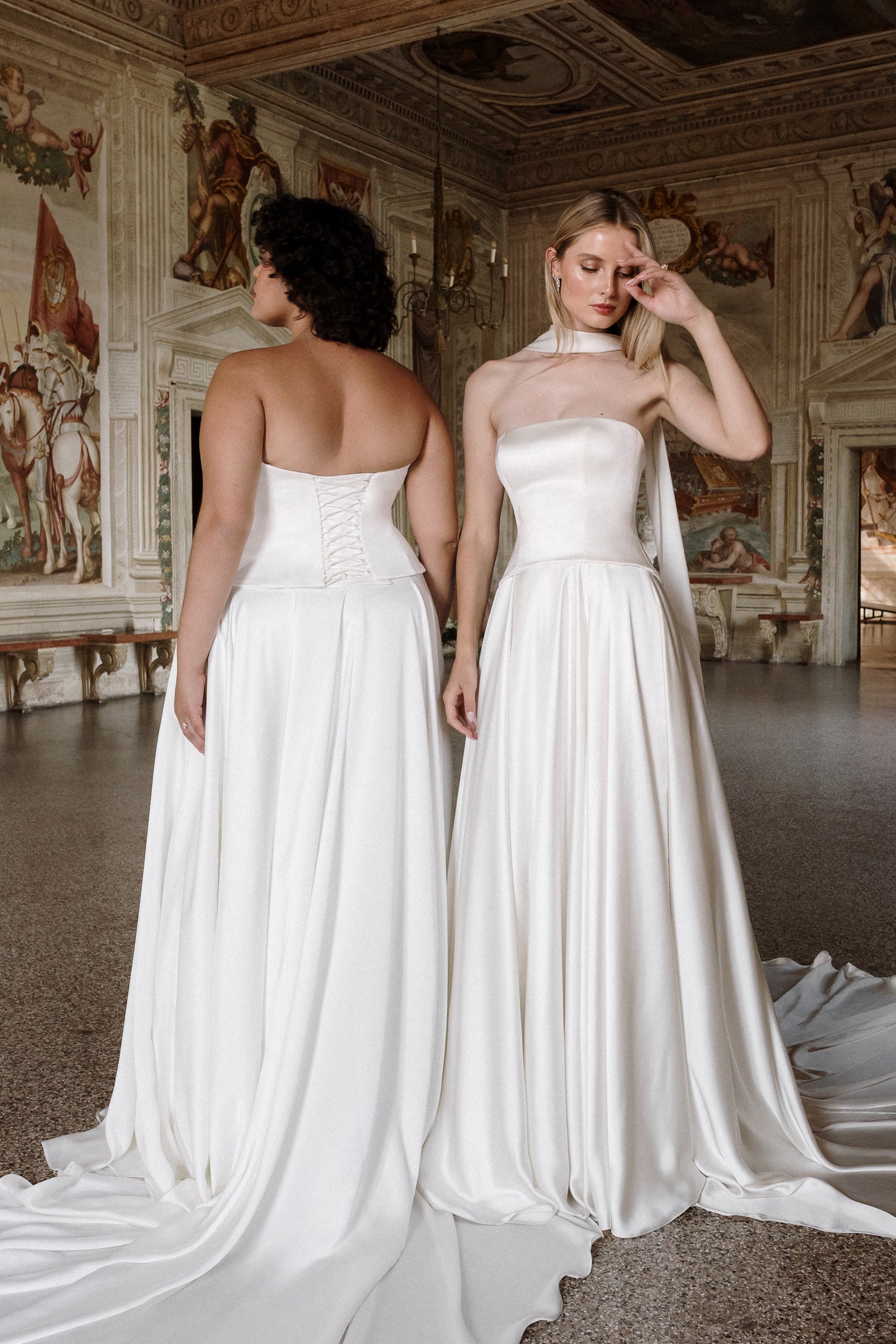 Gaia : A sleek satin wedding gown with a strapless neckline + a curved drop waist