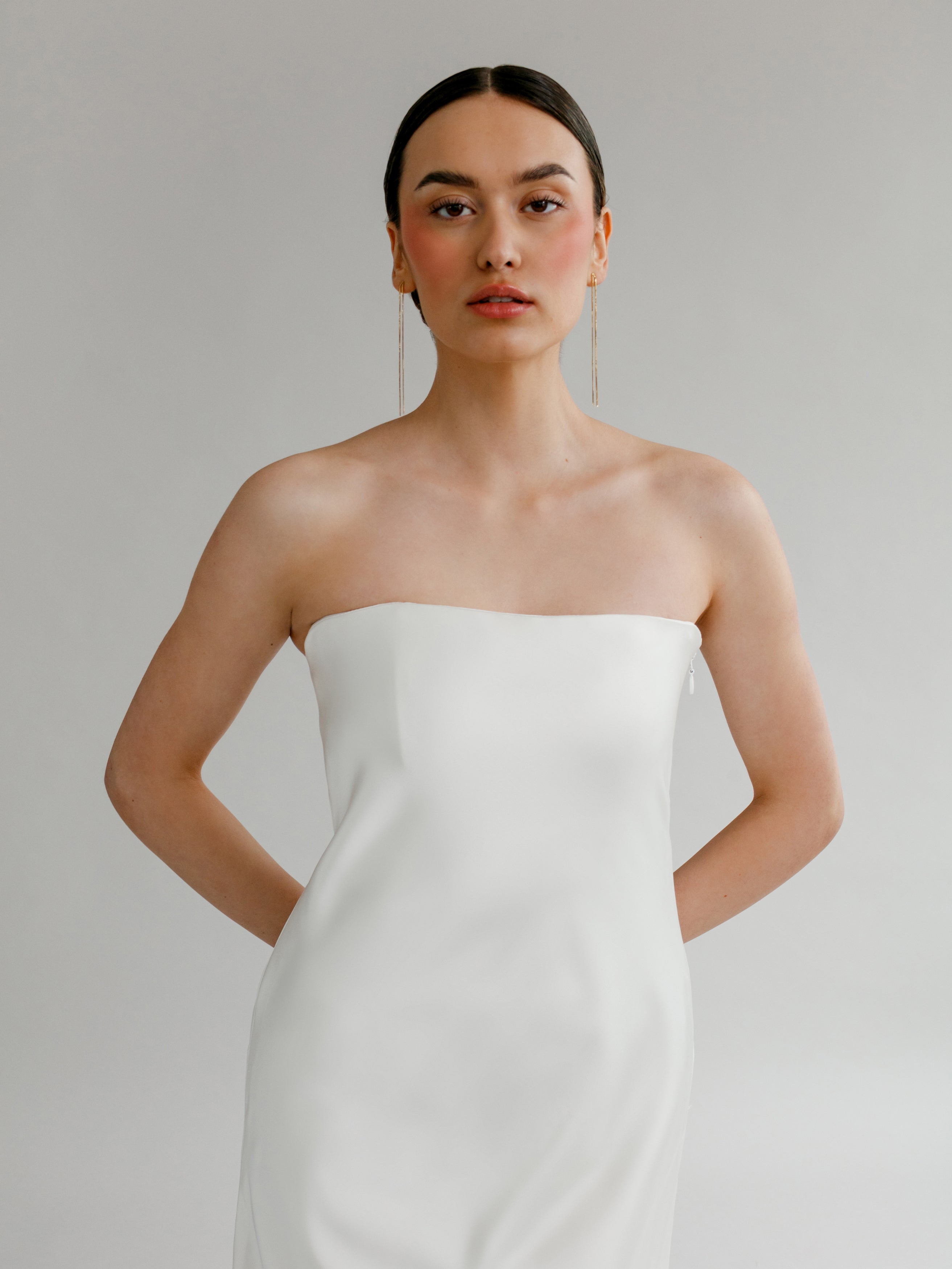 Leonora : A strapless, bias-cut wedding gown with a small train