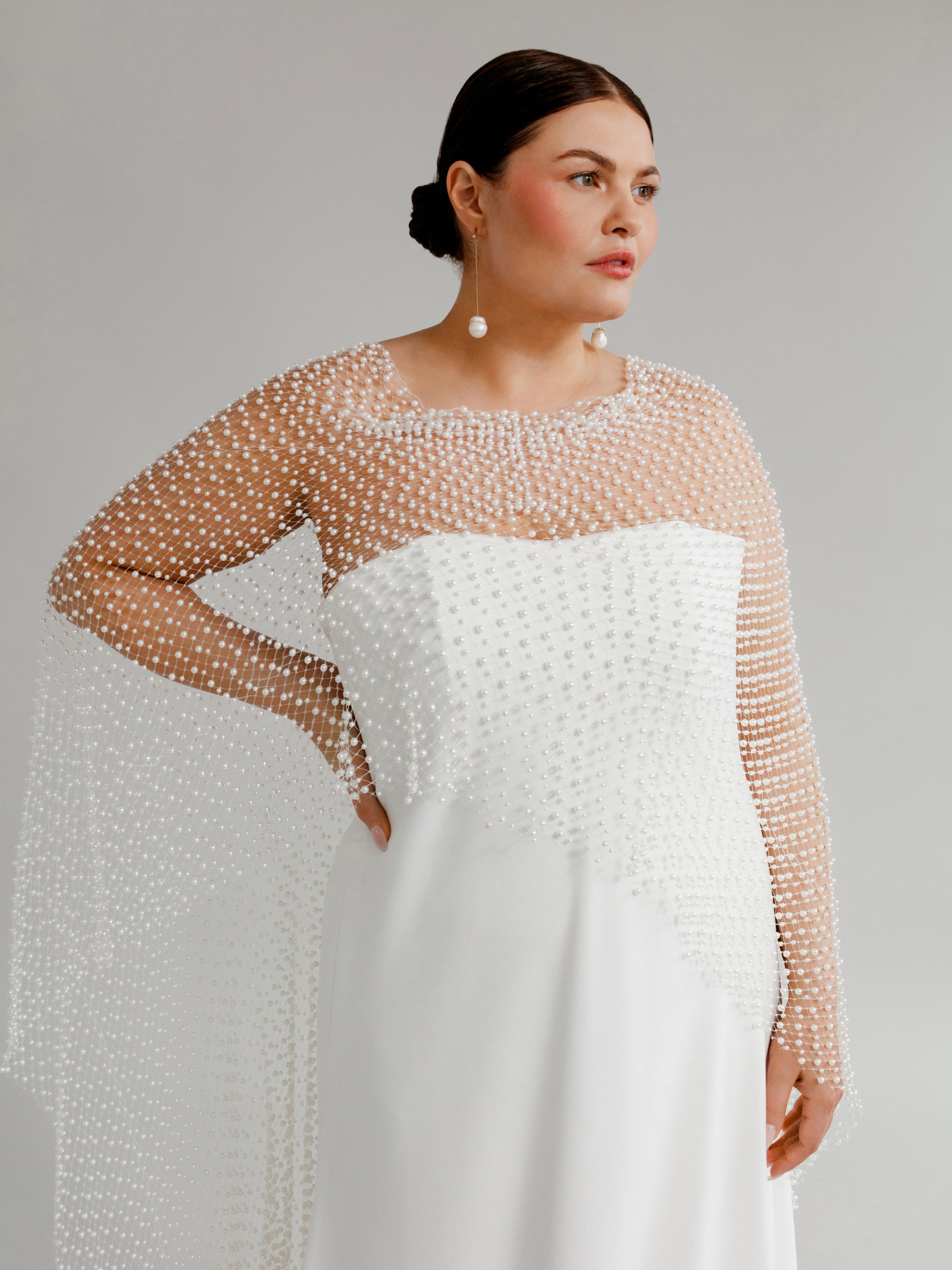 Leonora (With Cape) : A strapless, bias-cut wedding gown paired with a dramatic pearl cape