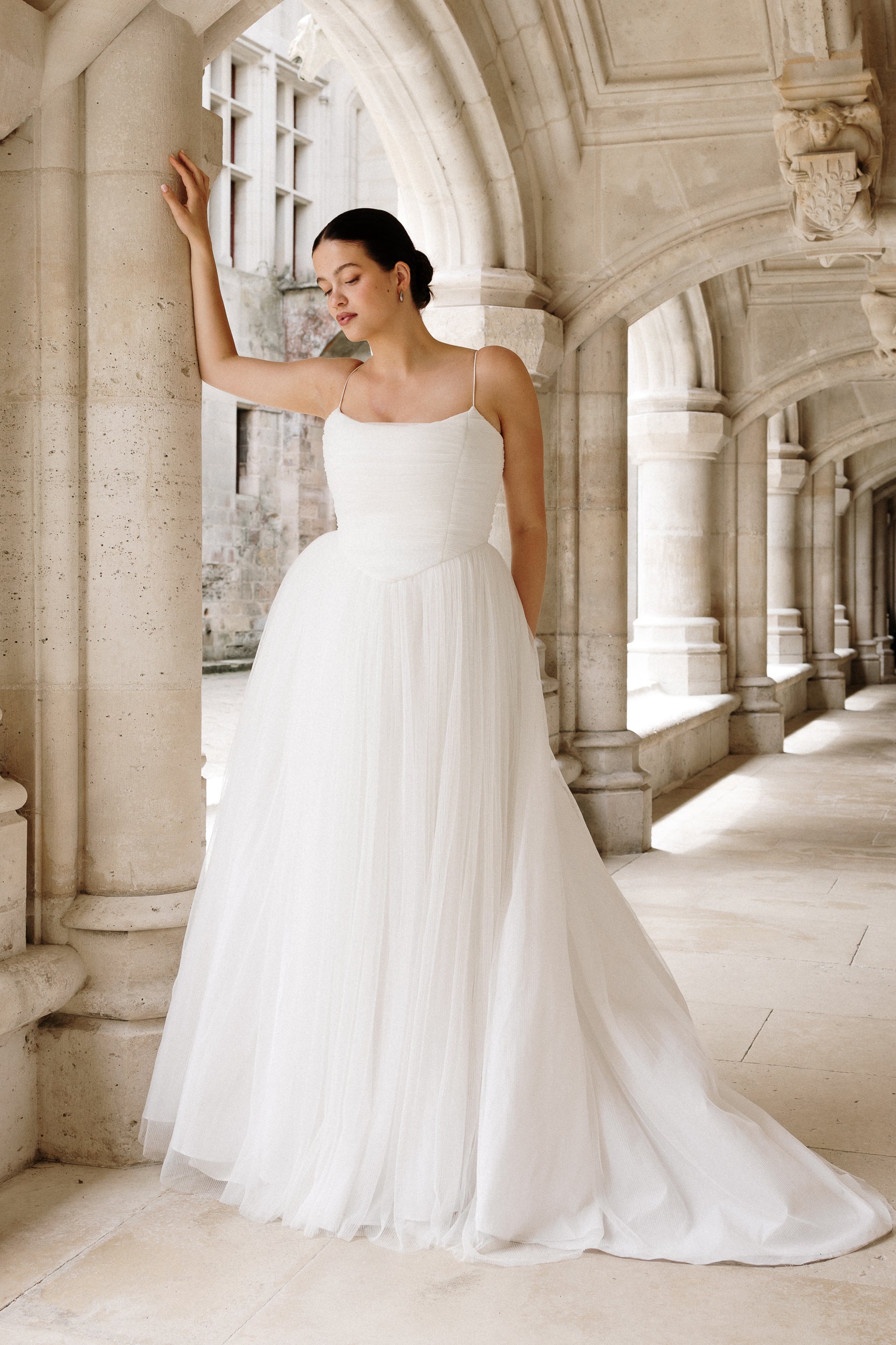 Lucia : An airy, crimped tulle wedding dress with delicate spaghetti straps and a basque waist